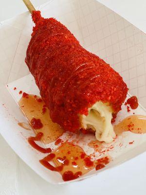 Half and half hot cheeto corndog with sweet chili glaze and ketchup added