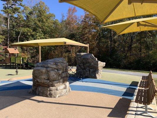 Climbing rope and rocks. Park benches with some shade.