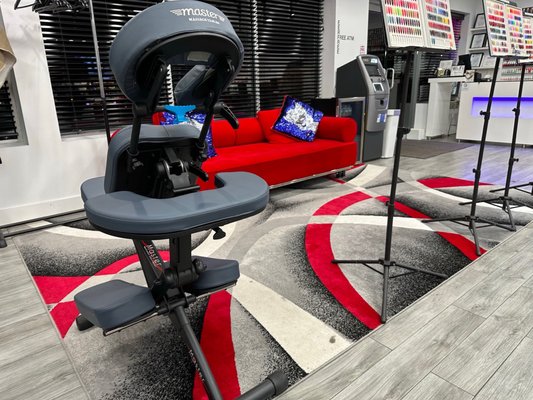 Cool waiting area with red couch and modern rug