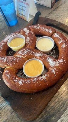 Giant pretzel with three dips: beer cheese, queso, and honey mustard