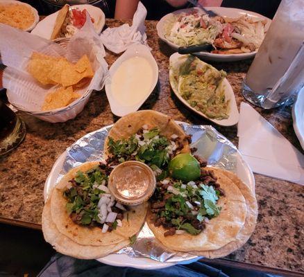 Steak tacos, beef gordita, cheese dip, guac, Pollo a la Diabla and a pitcher of horchata