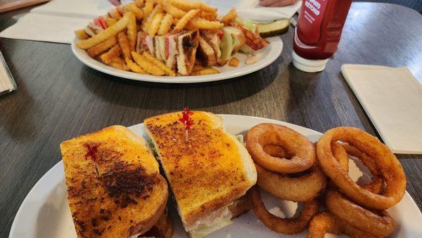 Turkey Bacon Club w/fries and Turkey, Bacon & Avocado w/onion rings.