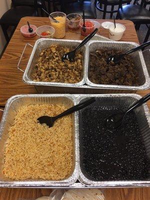 Mexican rice, black beans, chicken, beef, cheese, sour cream, tomatoes, cheese, veggies