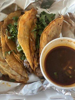 Birria tacos and consome