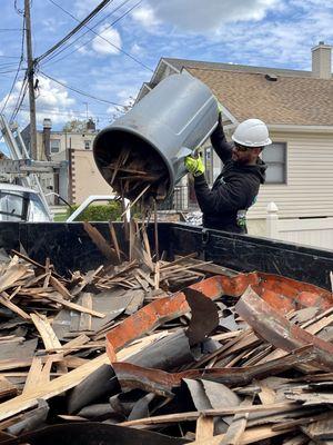 A member of our crew disposing of construction and demolition materials.