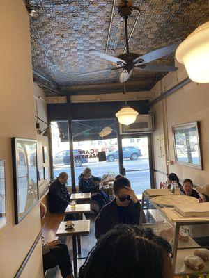 View of the seating area from the rear barista and pastry counter.