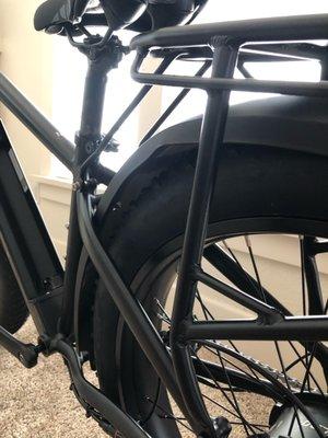 Fender assembled in a way that has it bent, rubbing on tire.