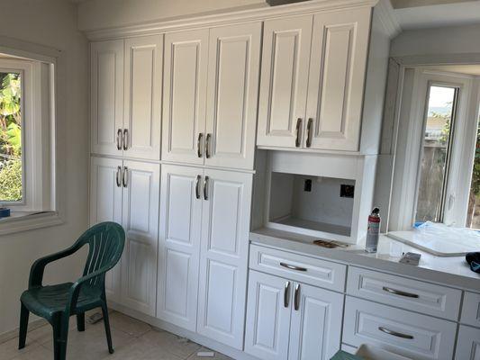 Completed cabinets with insert for a built-in microwave.