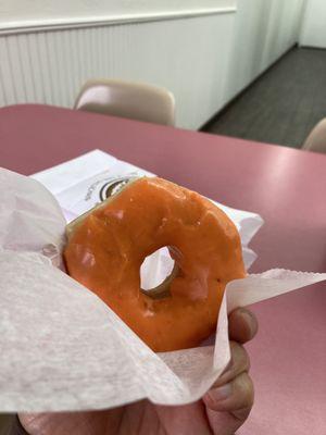 Sit down to enjoy the orange glazed donut