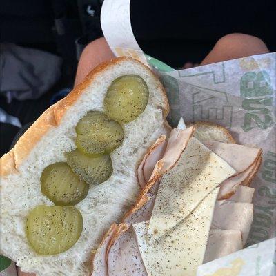 White bread with turkey and cheese and pickles