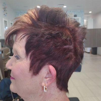 Chocolate cherry base color (touch-up) Golden peach foil highlights. Short woman's textured haircut