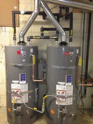 Two water heaters in series with bypass valves