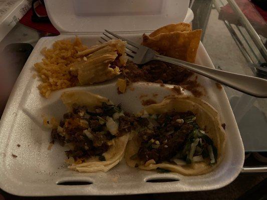 Two asada tacos and a red tamale W beans and rice