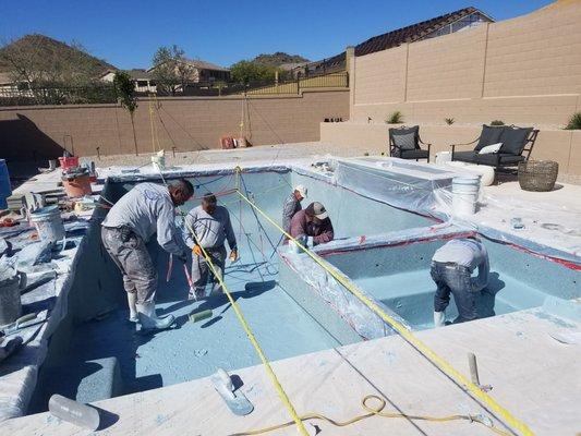 Soto crew working on a new pool and spa with Mini pebble.