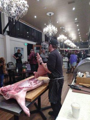 Matt demonstrates how to butcher pork at an event.