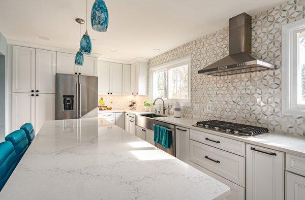 Kitchen remodel in Centreville, VA with wooden flooring and hooded chimney