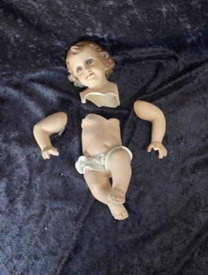 This is what the baby Jesus look like after I cleaned it up and separated the pieces to realign and start the restoration process.