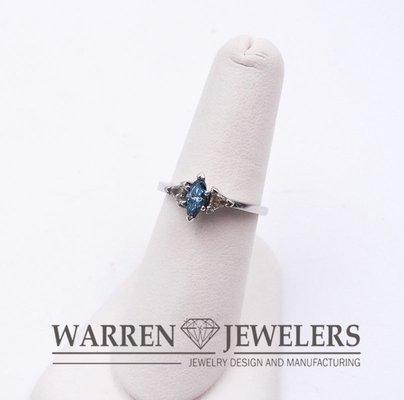 Simple, geometric Design featuring Blue Diamond in a Marquise Cut