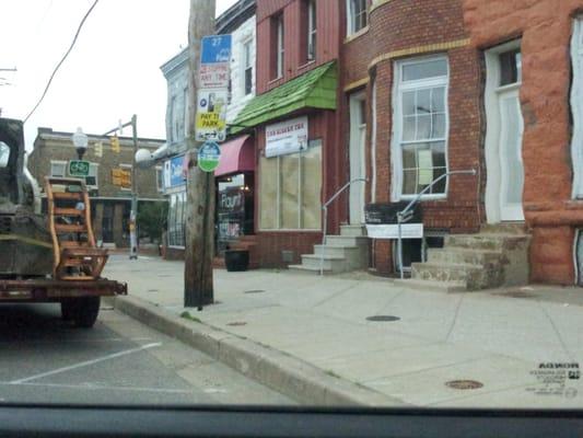 Street view. The pink awning is theirs.