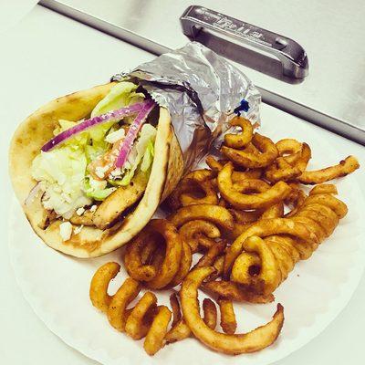 Grilled chicken gyro with curly fries.