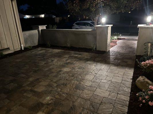 Patio pavers, wall, pillars and lighting system completed