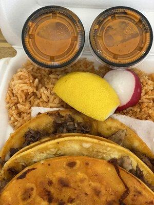 Quesabirria tacos and a side of rice with "orange salsa".