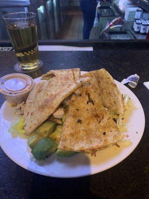 Bar area with a quesadilla salad. Even though it is pizza night .