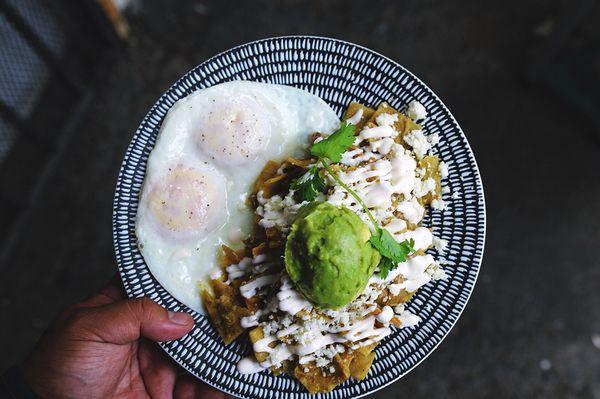 This is our chilaquiles plate with salsa verde, crema, queso fresco, avocado and eggs any style