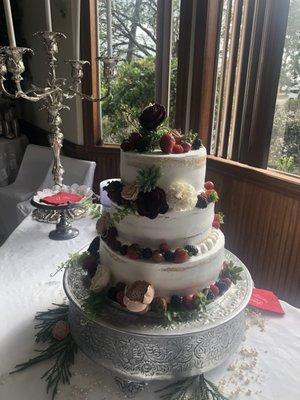 "Naked" wedding cake decorated with wood flowers and real fruit. Yummy!