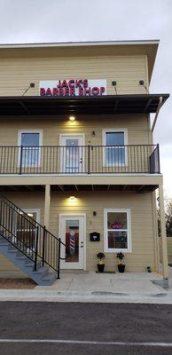 Jack's exterior view from side street. HWY 290 is to the right, one block away. To the right is Manor Lube.