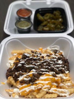 Loaded fries with jalapeños on the side