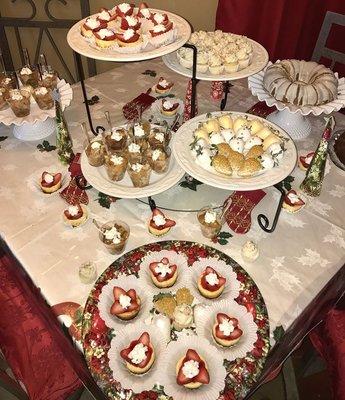 Christmas Dessert Table w/ Chocolate-covered Strawberries, Mini Cheesecakes, Peach Cobblers, Bite-size Funfetti Cupcakes and Lemon Cakes.