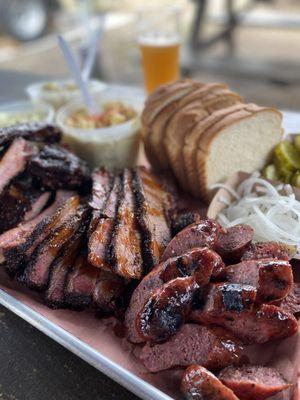 Sausage, brisket, ribs, sides, bread, pickles, onions