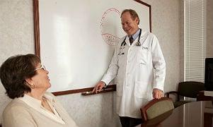 Dr. Tom with a patient in his office