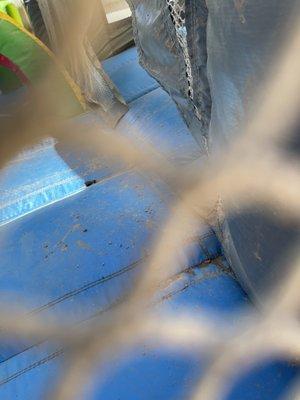 Inside of bounce house full of dirt and filthy.