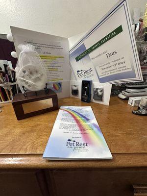 Certificate of cremation, His paw  print and clippings of his beautiful hair and his ashes in his box.