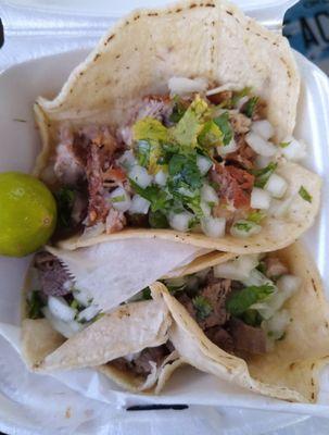 Carnitas taco on top, lengua below, both delicious (besides off cilantro sprig). Top with red salsa.