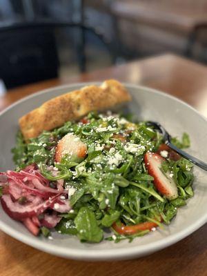 Arugula with fresh grapefruit dressing with sliced strawberries and sliced dates