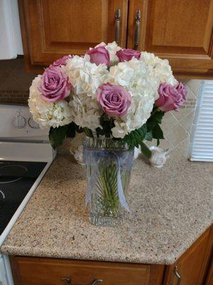 Simple but elegant. White hydrangeas with purple roses. I wanted peonies, but they are out of season.