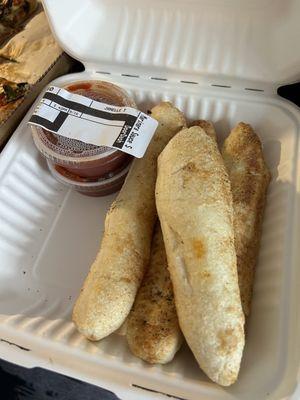 Breadsticks and sauce.  Looks like homemade breadsticks.  Plus in my book.