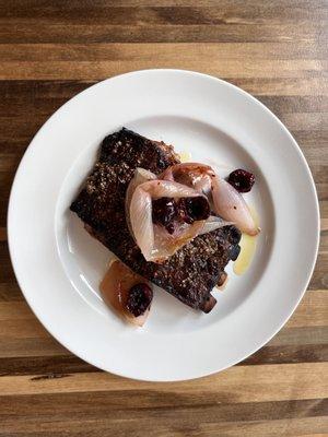 Coriander-crusted pork spare ribs with roasted onion, cherries and labne