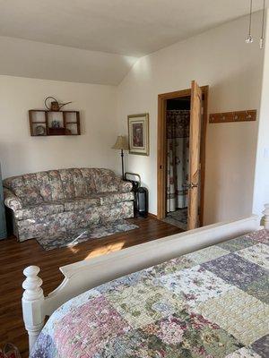 Garden cabin, couch and door to bathroom