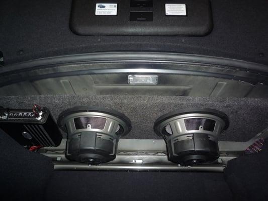 Adding bass to a BMW 5 series.  Two Audiomobile subwoofers and an ARC Audio mono amplifier.