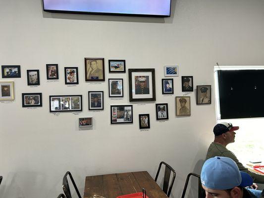 Dining room wall decorated with military photos of owners' family members.