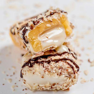 Passion Fruit filled with Condensed Milk Paleta dipped in White Chocolate, topped with Almonds, & drizzled with Dark Chocolate