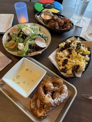 Pretzels, popcorn, salad and tater barrels