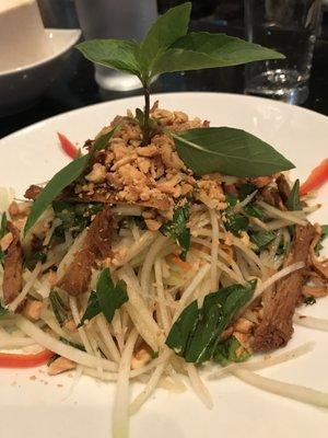 Green papaya salad is a guest favorite, with vegan fish sauce  and tossed with peanuts, Thai basil & vegan housemade beef jerky. A delight!