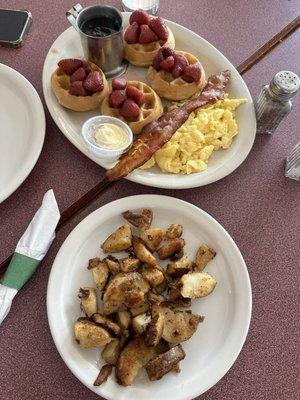 Mini Belgian waffles with strawberries (delicious!). Side of eggs, bacon, home fries.