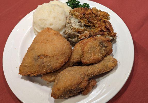 Lightly breaded, well-seasoned fried chicken with mashed potatoes and stuffing.