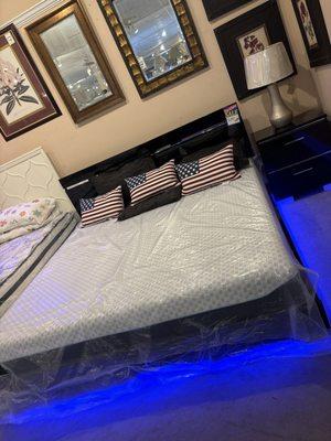 A black super king size bed with mattress.